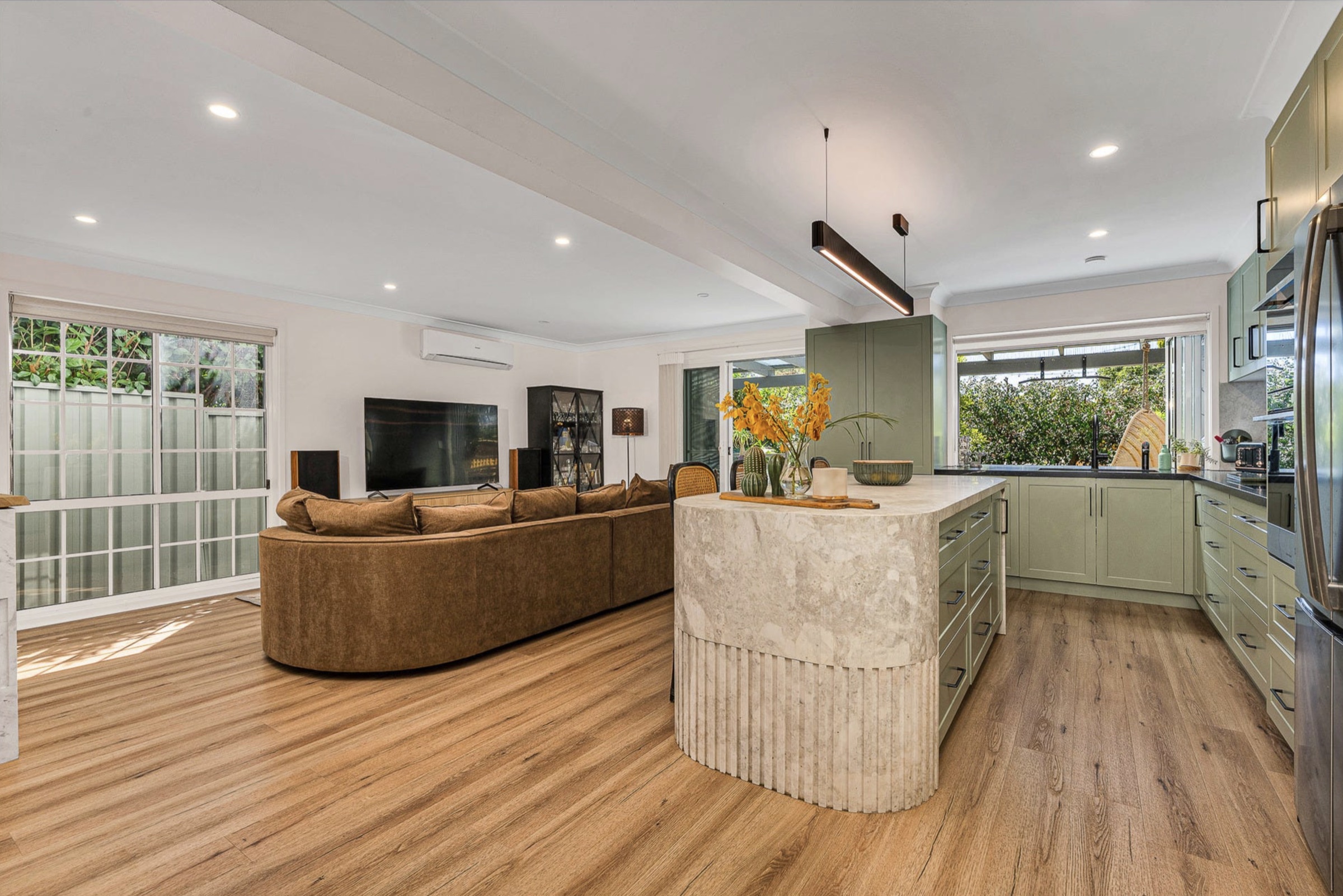Open-plan living and kitchen with the stone island at its centre