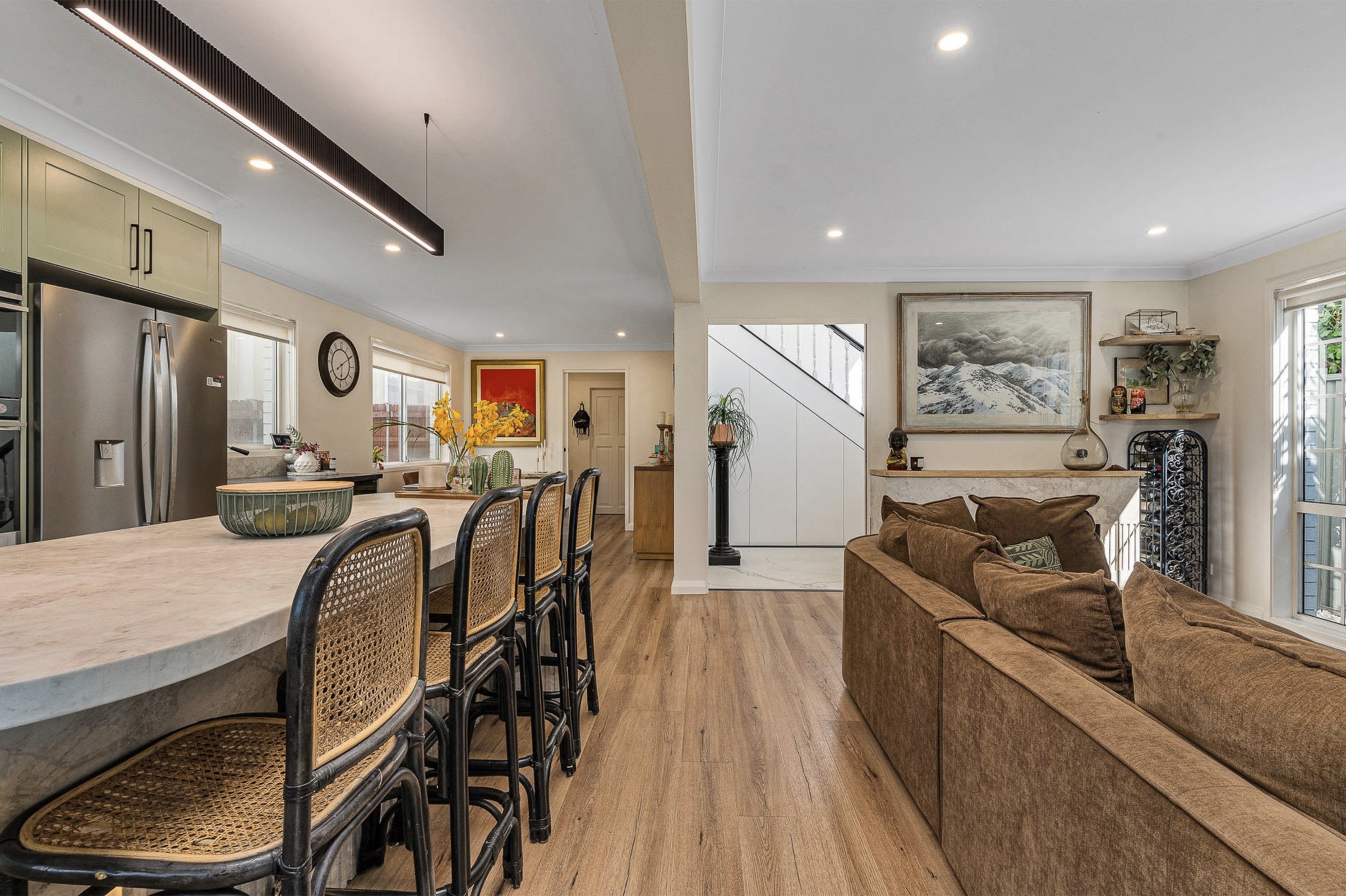 Extended stone servery and dining flowing toward the entry
