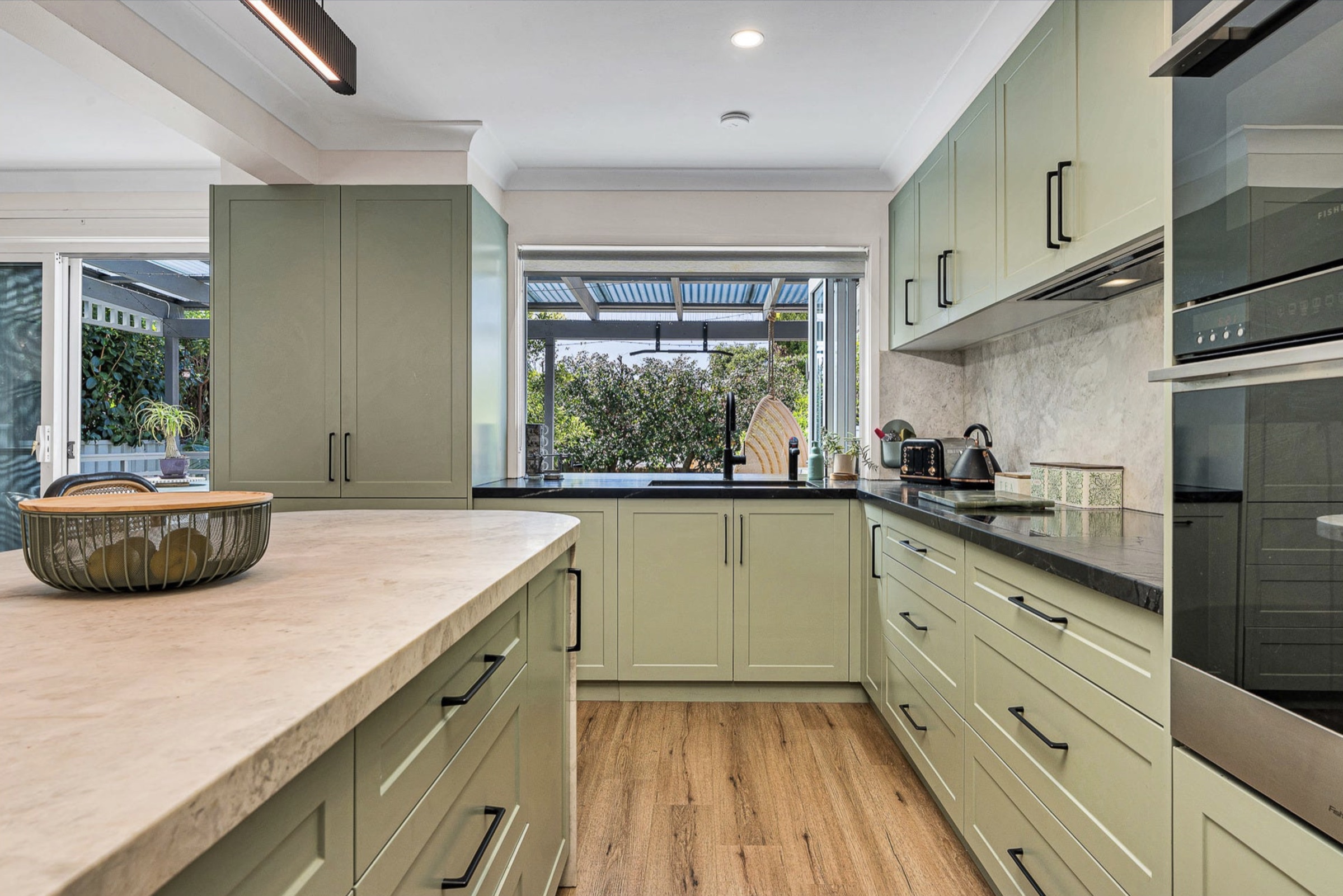 Negresco Quartzite benchtops and splashback around the cooktop and sink